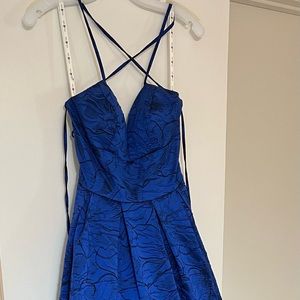 Blue Jaquard cries cross tie back ball gown